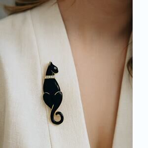 Vintage black cat brooch with rhinestone collar, gold trim, feline pin, elegant